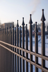Image of a Beautiful decorative cast iron wrought fence with artistic forging. Metal guardrail close up.