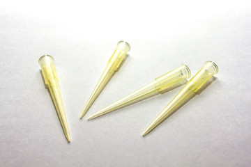 A yellow disposable micro pipette tips for lab or laboratory on white background
