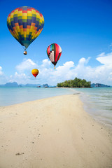 Fototapeta na wymiar Colorful hot air balloon fly over the sea.