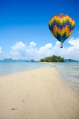 Colorful hot air balloon fly over the sea.