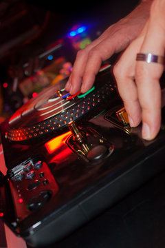 Male hands playing dj with toy turntable on a party