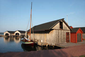 Fototapeta na wymiar Old sheds and boats in shipyard in Marienhamn