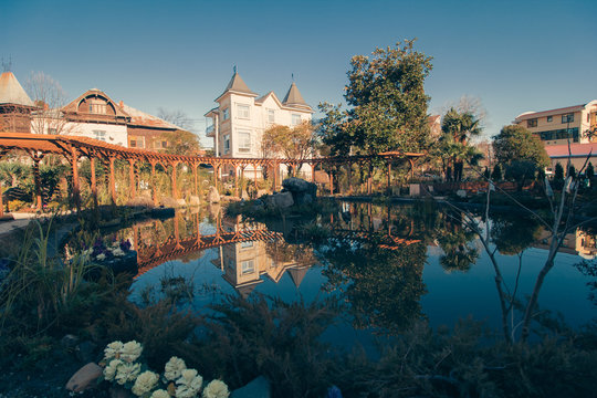 landscape park with a pond and a wooden gazebo