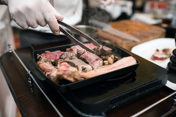 Man hand at a barbecue with meat and pepper..