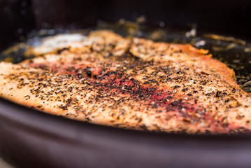 Roasting fish fillet on frying pan close