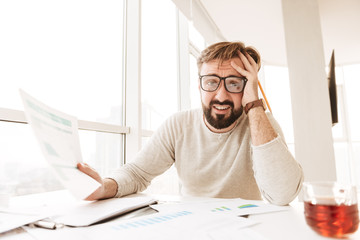 Portrait of a desperate man working with documents