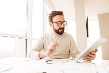 Portrait of a concentrated man working with documents