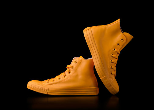 Yellow Sneakers On A Black Background.