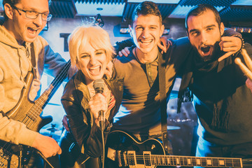 Rock band musicians on stage after successful concert