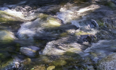 River water with rocks and waterfalls