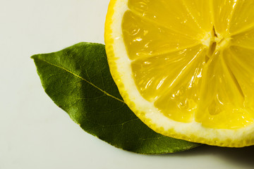 cut lemon with green leaves