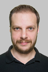 Fototapeta premium Portrait of adult bearded man against gray background.