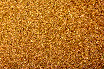golden background with sparkles texture of large resolution yellow shiny and iridescent sequins with lights and light background