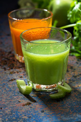 glasses of fresh juice from celery and carrots, vertical, closeup