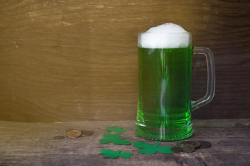 St Patrick's Day concept green beer with shamrock and coins on w