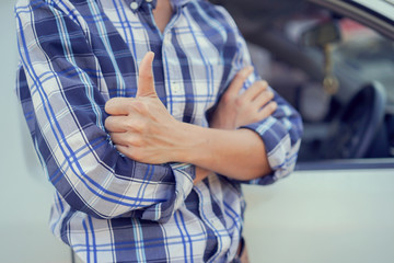 close up driver man hand outstretched arms showing thumb up over car for make sure for safety and assurance of driving concept