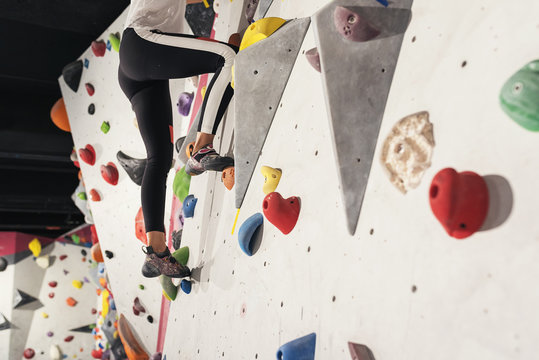 Close Up Of Woman Practicing Rock Climbing On Artificial Wall Indoors.