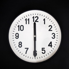 wall clock ion black background . place for text.