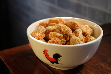 A bowl of Chinese sesame cookies. It is a traditional Chinese New Year festival snack in Guangdong province. Its also has a nickname of "laughing mouth cookie".