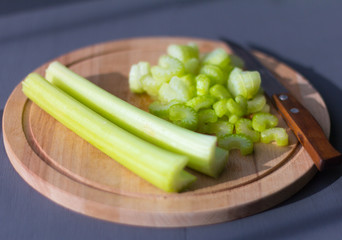 fresh,juicy celery diced on a cutting Board