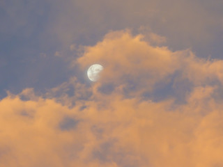 Cloudy pink sunset the moon in Uruguaiana, Brazil