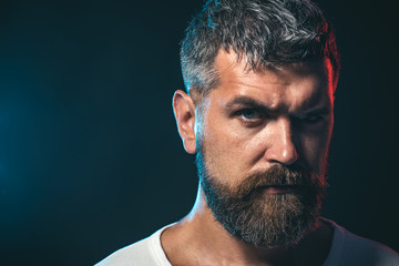 Obraz premium Applying focus and power - martial arts. Individual martial art sport. Male karate instructor closeup on dark background. Portrait of boxer before fight, closeup. Copy space.