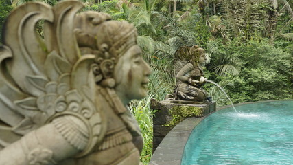 Fototapeta na wymiar Statue of a girl at a pool on Bali