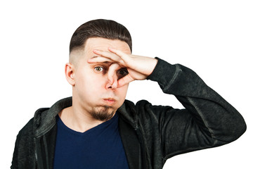 Closeup portrait of handsome guy, closing nose, something stinks. Negative human face expressions, emotions, feelings, reaction, attitude, behavior, perception