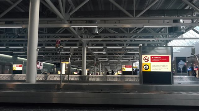 International Airport Baggage Claim Area. A baggage carousel is a device that delivers checked luggage to the passengers at the baggage claim area.