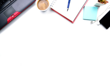 Top view or Flat lay style with copy space of workspace with laptop , pen , notebook , cup of coffee , sticky note and mobile phone and earphone on white table background or isolated