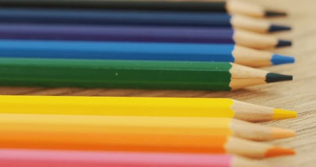 Top view of the colourful pencils lying on the table in the line. Macro. Close up - Powered by Adobe