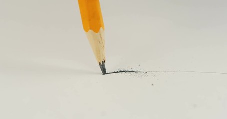Close up of the female hand drawing a line on the sheet of paper and breaking. Macro - Powered by Adobe
