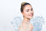Young beautiful woman with water splash