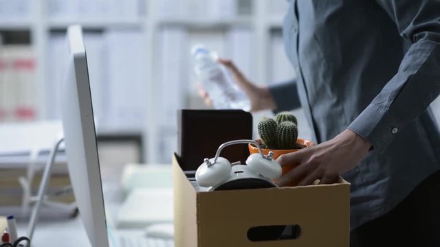 Fired employee packing and leaving the office