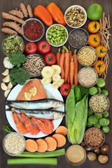 Health food concept with fresh seafood, vegetables, fruit, seeds, grains, cereals, herbs and spices with foods high in omega 3 fatty acids, antioxidants, anthocyanins, fibre, minerals and vitamins.  