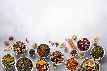 Assortment of dry tea in white bowls. Tea types backgound: green, black, floral, herbal, mint,...