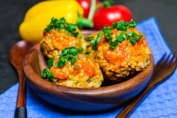 Meatballs with rice and meat in a wooden dish. Place for your text.