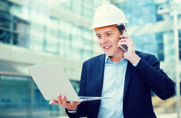 Cheerful male talking about work at the laptop