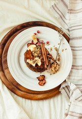 Chocolate pancakes with banana, peanut butter, green buckwheat and strawberries. Gluten-free fried sweet breakfast, vegan dessert.Copy space.