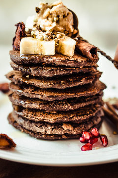 Chocolate pancakes with banana, peanut butter, green buckwheat and strawberries. Gluten-free sweet breakfast, vegan dessert.Maslenitsa.