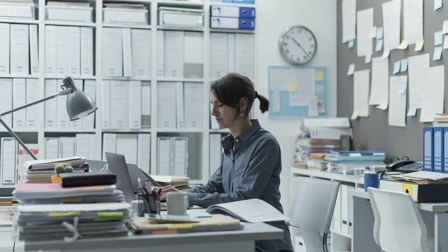 Efficient businesswoman working in her office