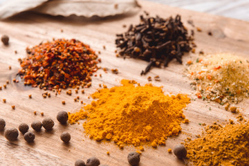 different spices on a white wooden table