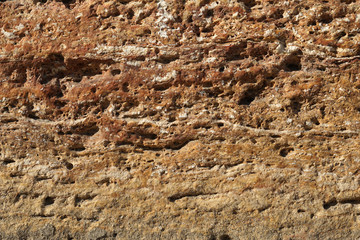 Texture background of old natural stone brick wall in yellow with joint and rough surface, Old Bazar in Skopje