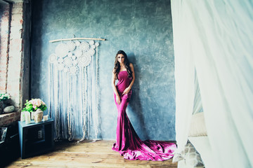 Beautiful Stylish Fashion Model Woman in Lilac Dress Posing in Boho Chic Style Interior