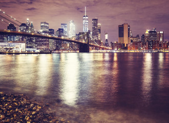 Brooklyn Bridge and the Manhattan at night, color toned picture, New York City, USA.