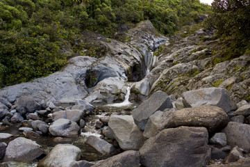 Cascade falls over  rocks