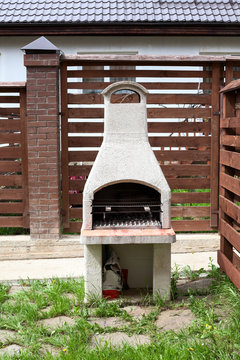 Stone garden oven for grill or barbeque is in backyard at summer season