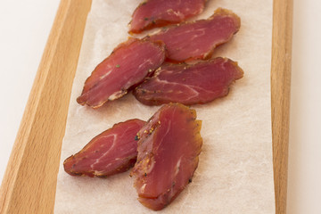 Slices of smoked meat on a white background.