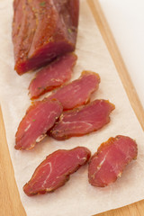 Slices of smoked meat on a white background.