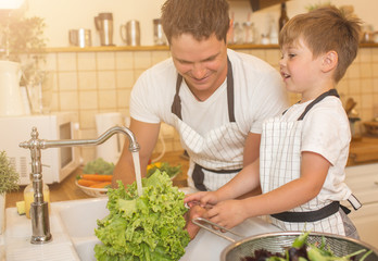 Man and boy washing vegetables before eating